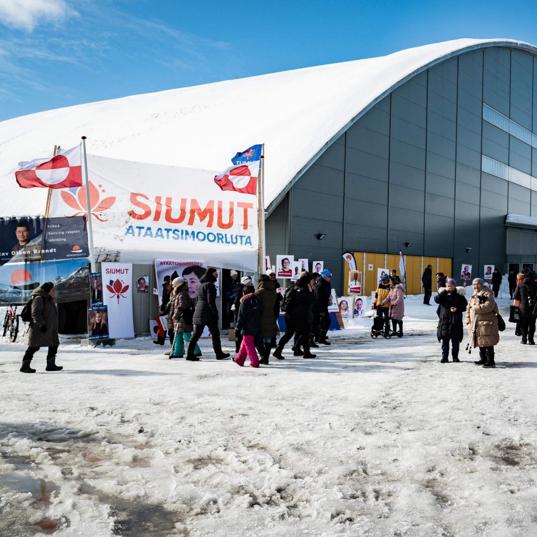 Voters stand in line to cast their ballots in the parliamentary election in Greenland's capital of Nuuk on April 6, 2021. 