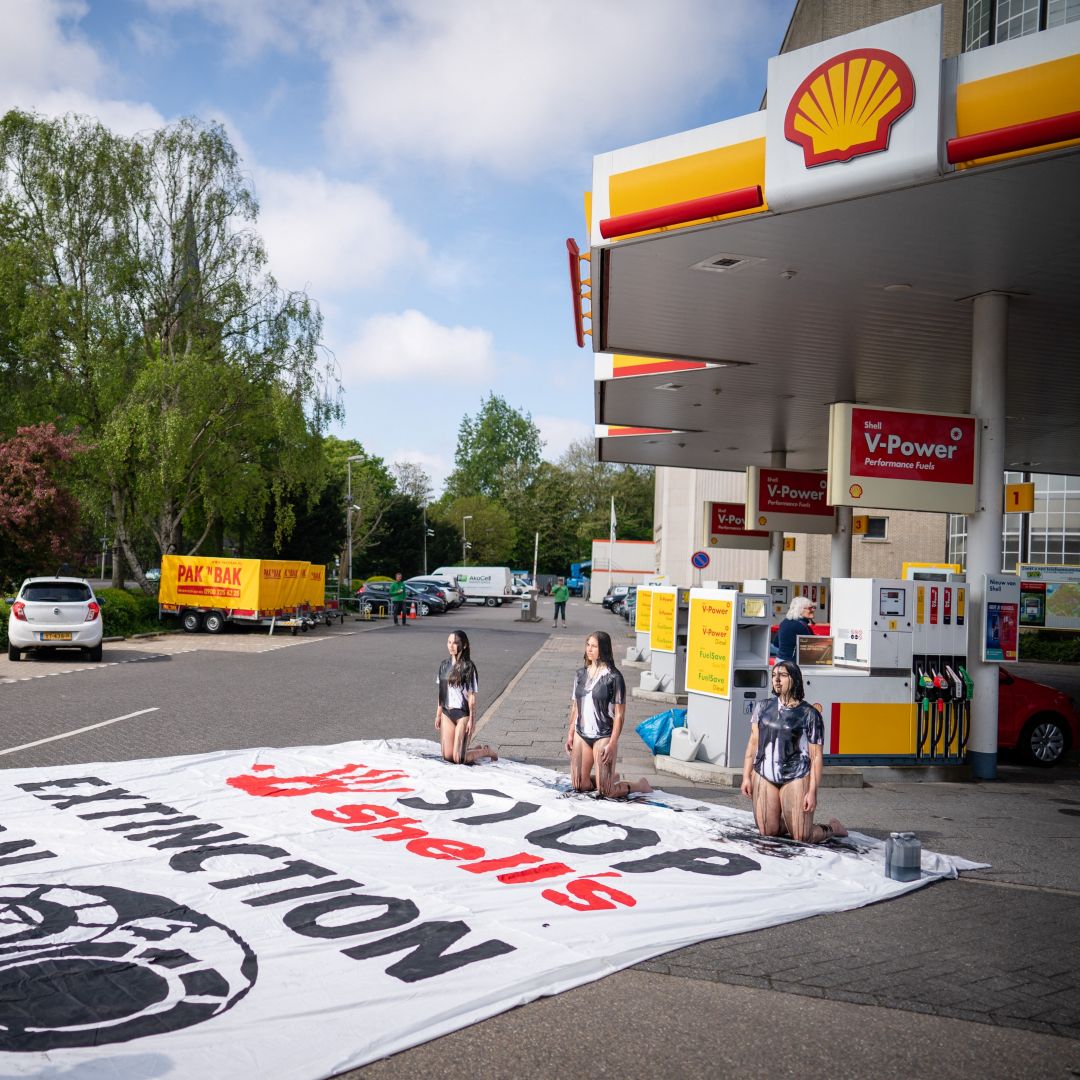 Environmental activists covered in black paint take part in a demonstration at a Shell gas station in The Hague, Netherlands, on May 18, 2021. Environmental activists covered in black paint take part in a demonstration at a Shell gas station in The Hague, Netherlands, on May 18, 2021.