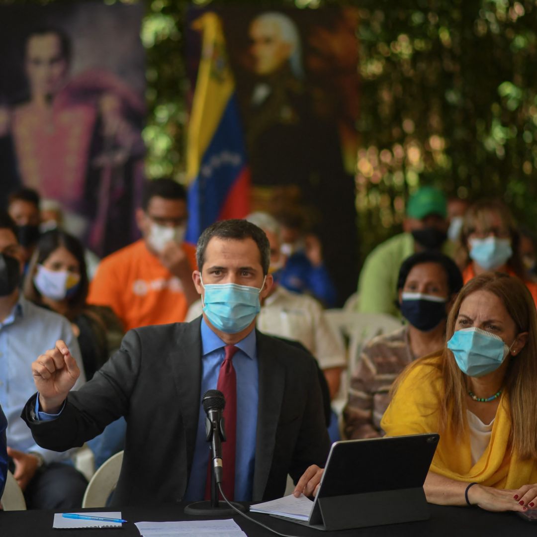 Venezuelan opposition leader Juan Guaido (center) speaks during a press conference at a park in Caracas on June 30, 2021. 