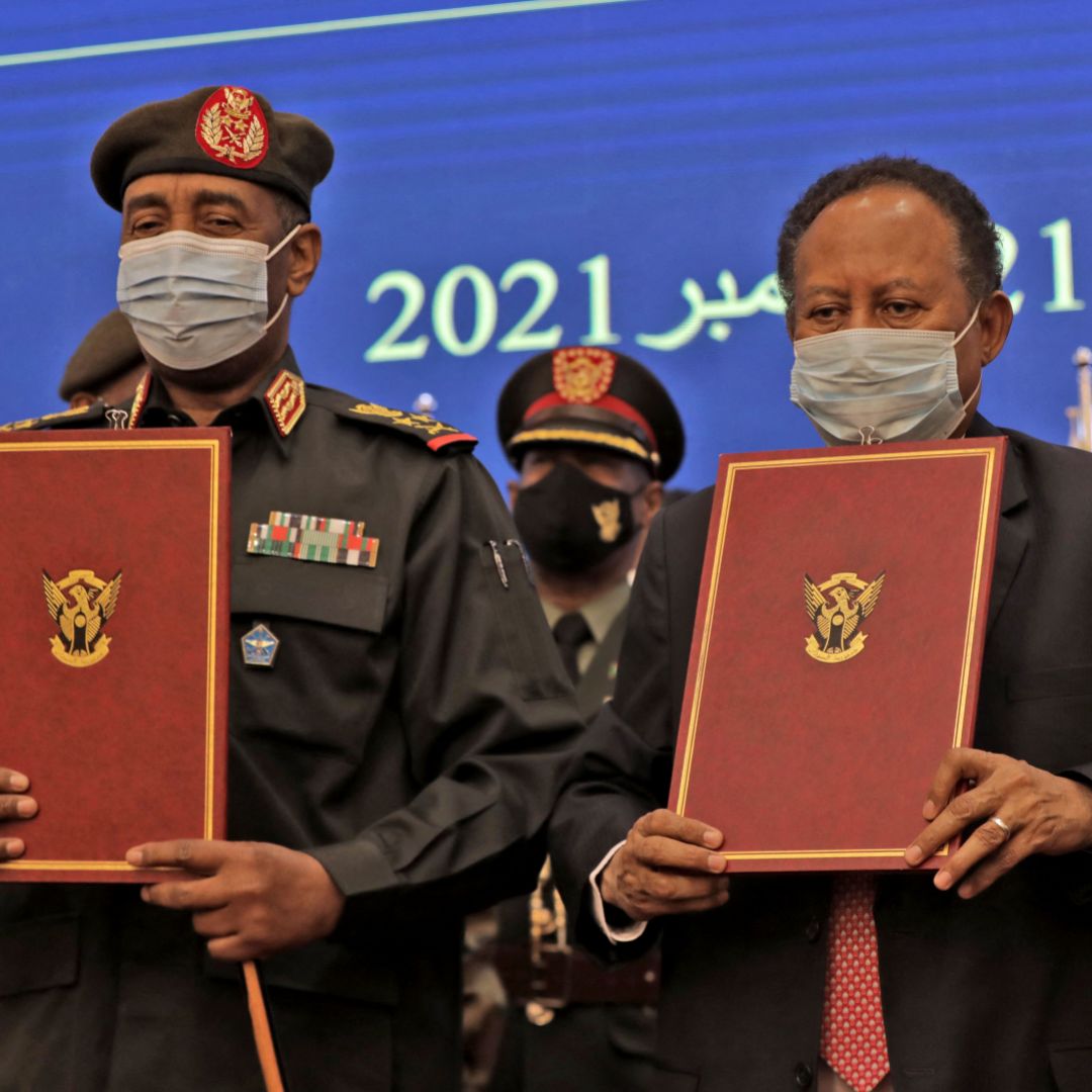 Sudan’s military chief (left) and prime minister show documents during a deal-signing ceremony in Khartoum on Nov. 21, 2021. Sudan’s military chief (left) and prime minister show documents during a deal-signing ceremony in Khartoum on Nov. 21, 2021.