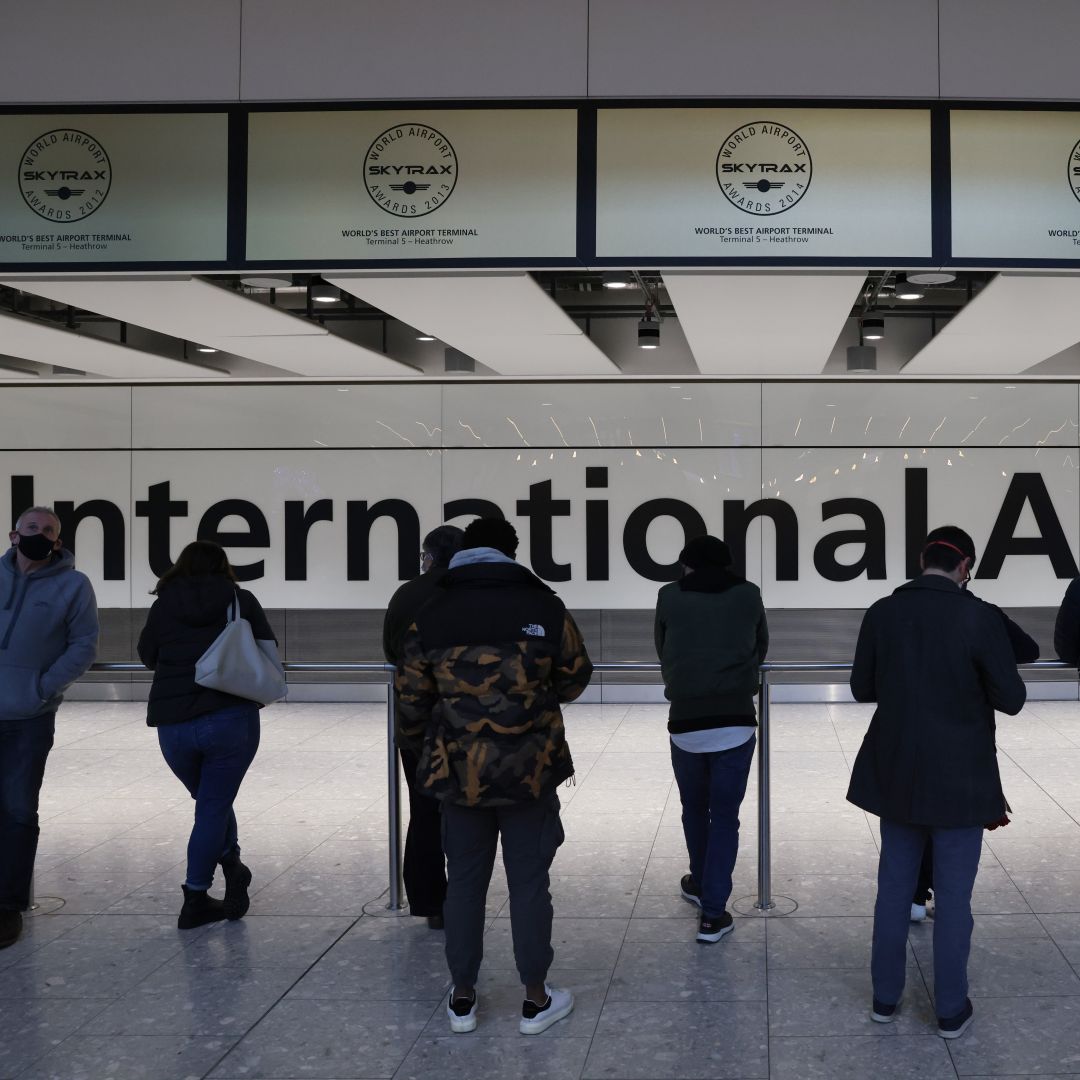 People wait at the international arrivals gate at London’s Heathrow Airport on Nov. 28, 2021. The United Kingdom recently imposed new travel restrictions following the discovery of the Omicron COVID-19 variant. 