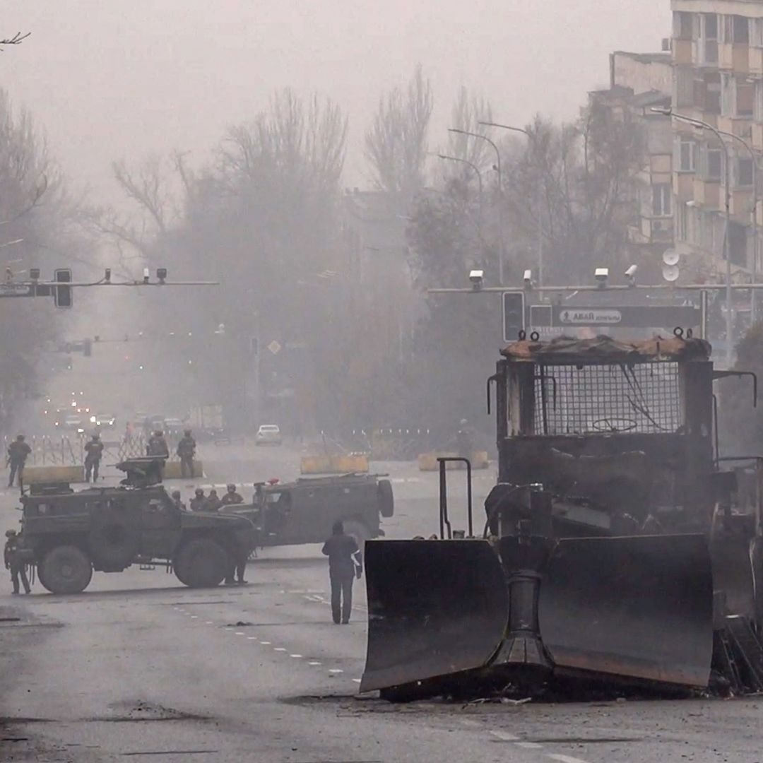 Servicemen and their military vehicles block a street in Almaty, Kazakhstan, on Jan. 7, 2022, following violent protests in the city. 