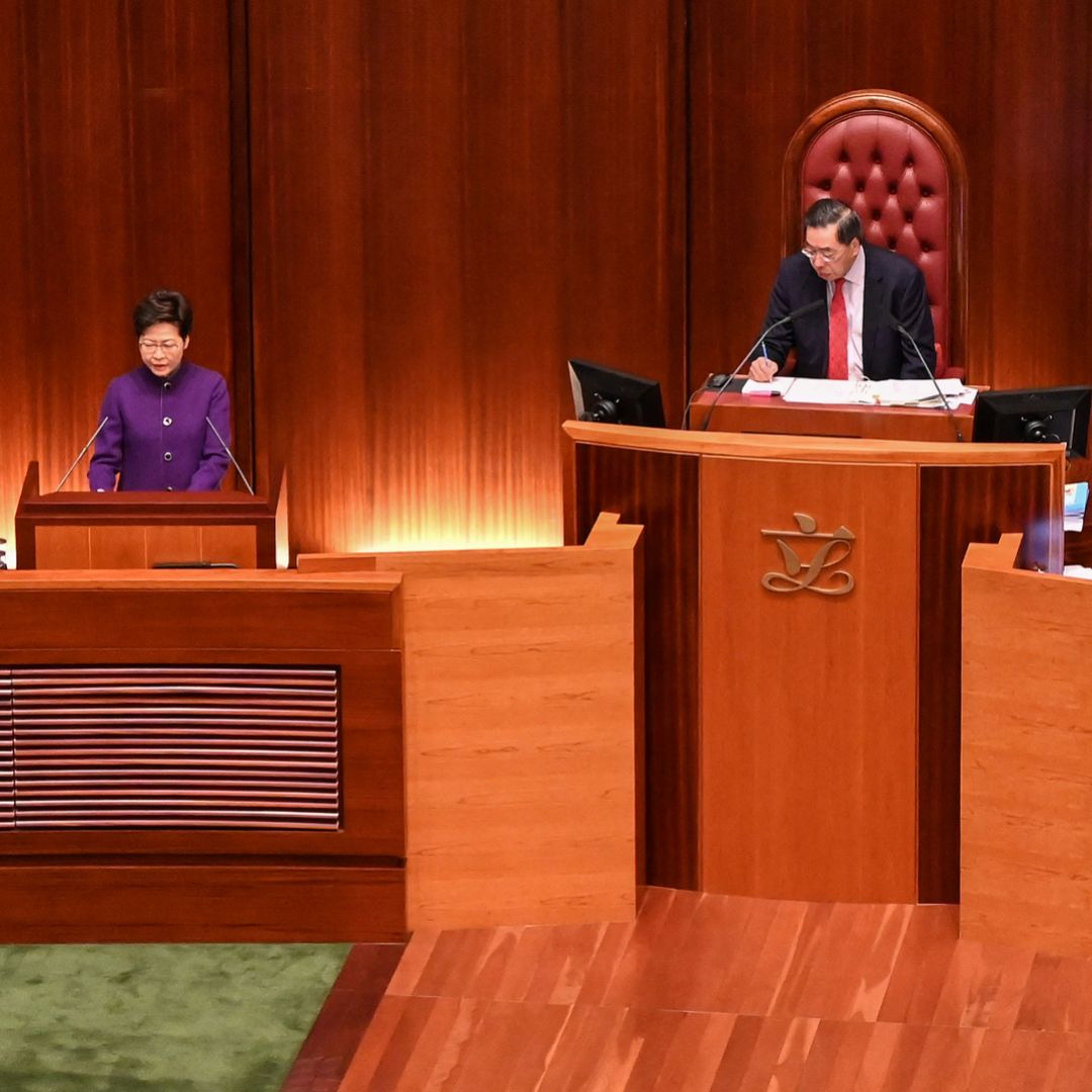 The president of Hong Kong’s Legislative Council, Andrew Leung (center), looks on as Chief Executive Carrie Lam (left) makes an address during the first session of the newly elected legislature on Jan. 12, 2022. 