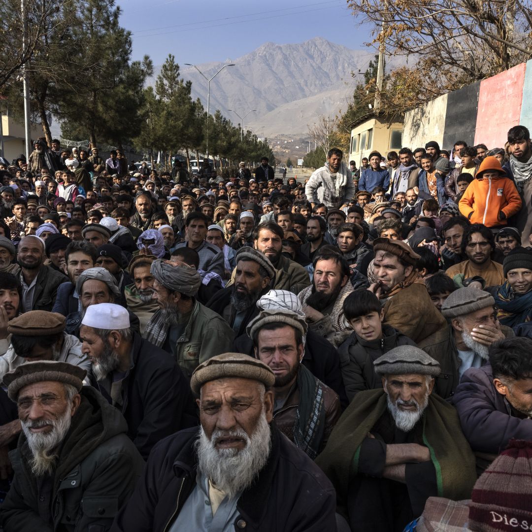 Hundreds of villagers desperate for humanitarian aid wait for hours outside a government center to register on Dec. 6, 2021, in Charikar, Afghanistan. Hundreds of villagers desperate for humanitarian aid wait for hours outside a government center to register on Dec. 6, 2021, in Charikar, Afghanistan.