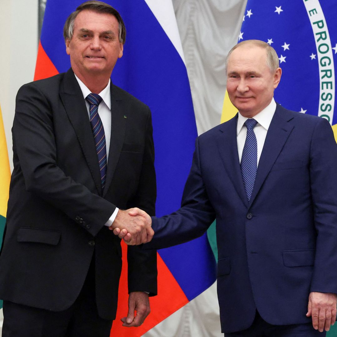 Russian President Vladimir Putin (right) shakes hands with Brazilian President Jair Bolsonaro during a joint press conference after holding a meeting in Moscow on Feb. 16, 2022. 