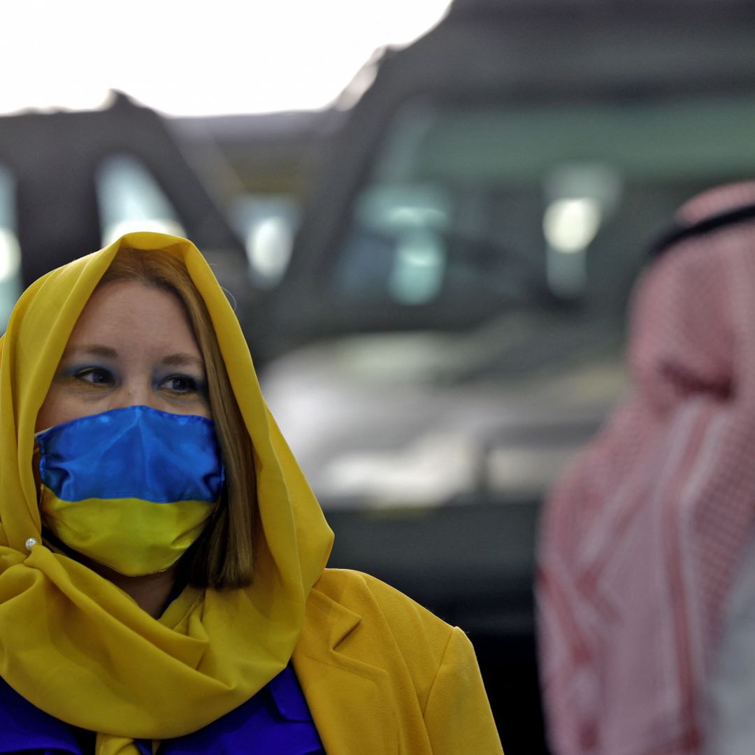 A worker at one of the stands at Saudi Arabia's first World Defense Show in Riyadh is seen wearing clothes in support of Ukraine on March 8, 2022.