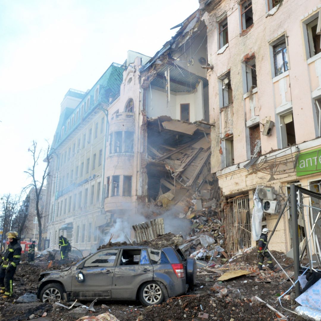 Firemen work to clear the rubble after a Russian rocket exploded just outside the Ukrainian city of Kharkiv on March 14, 2022. 