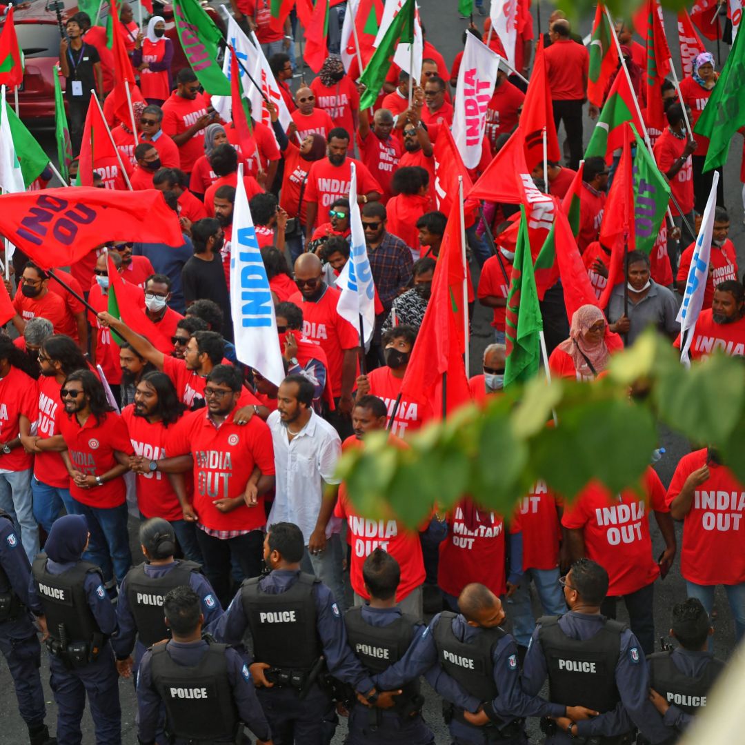 Police stand guard in Male, the Maldives, as protesters take part in an anti-India rally organized by the island nation's opposition coalition on March 25, 2022. 