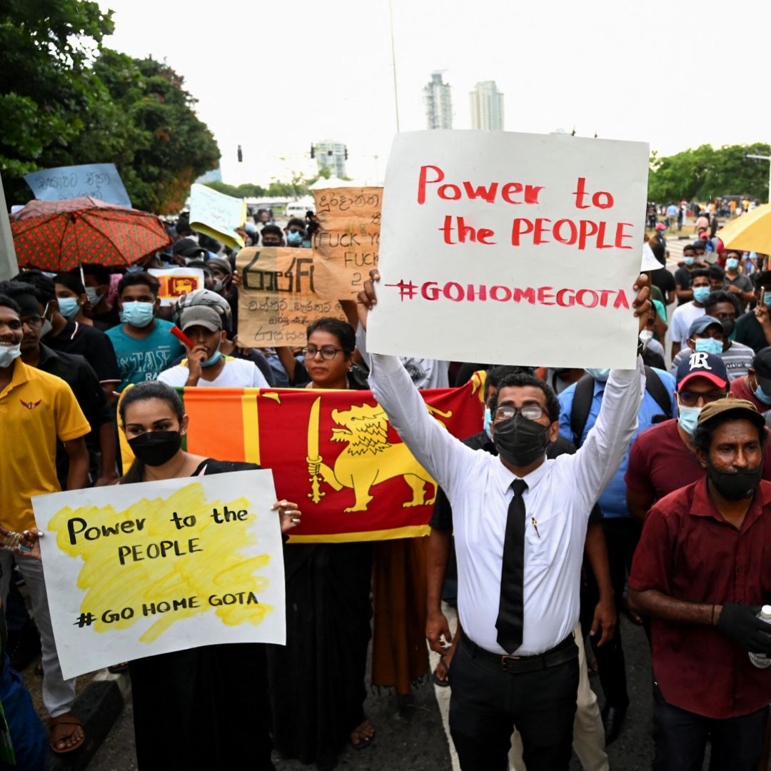 People hold up posters with ''#GoHomeGota,'' a slogan used to call for the resignation of Sri Lankan President Gotabaya Rajapaksa, at an anti-government protest in Colombo on April 5, 2022 People hold up posters with ''#GoHomeGota,'' a slogan used to call for the resignation of Sri Lankan President Gotabaya Rajapaksa, at an anti-government protest in Colombo on April 5, 2022