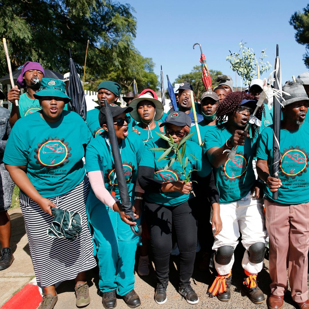 Striking workers affiliated with the Association of Mineworkers and Construction Union (AMCU) sing outside of Sibanye-Stillwater's Driefontein gold mine near Carletonville, South Africa, on May 6, 2022.