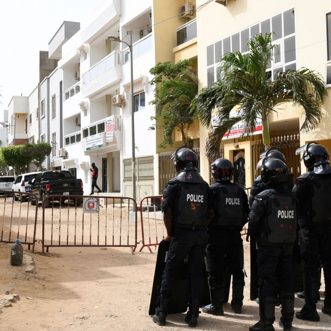 Police are seen at the entrance of the street leading to the house of Senegalese opposition leader Ousmane Sonko on June 17, 2022, in Dakar. Police are seen at the entrance of the street leading to the house of Senegalese opposition leader Ousmane Sonko on June 17, 2022, in Dakar.