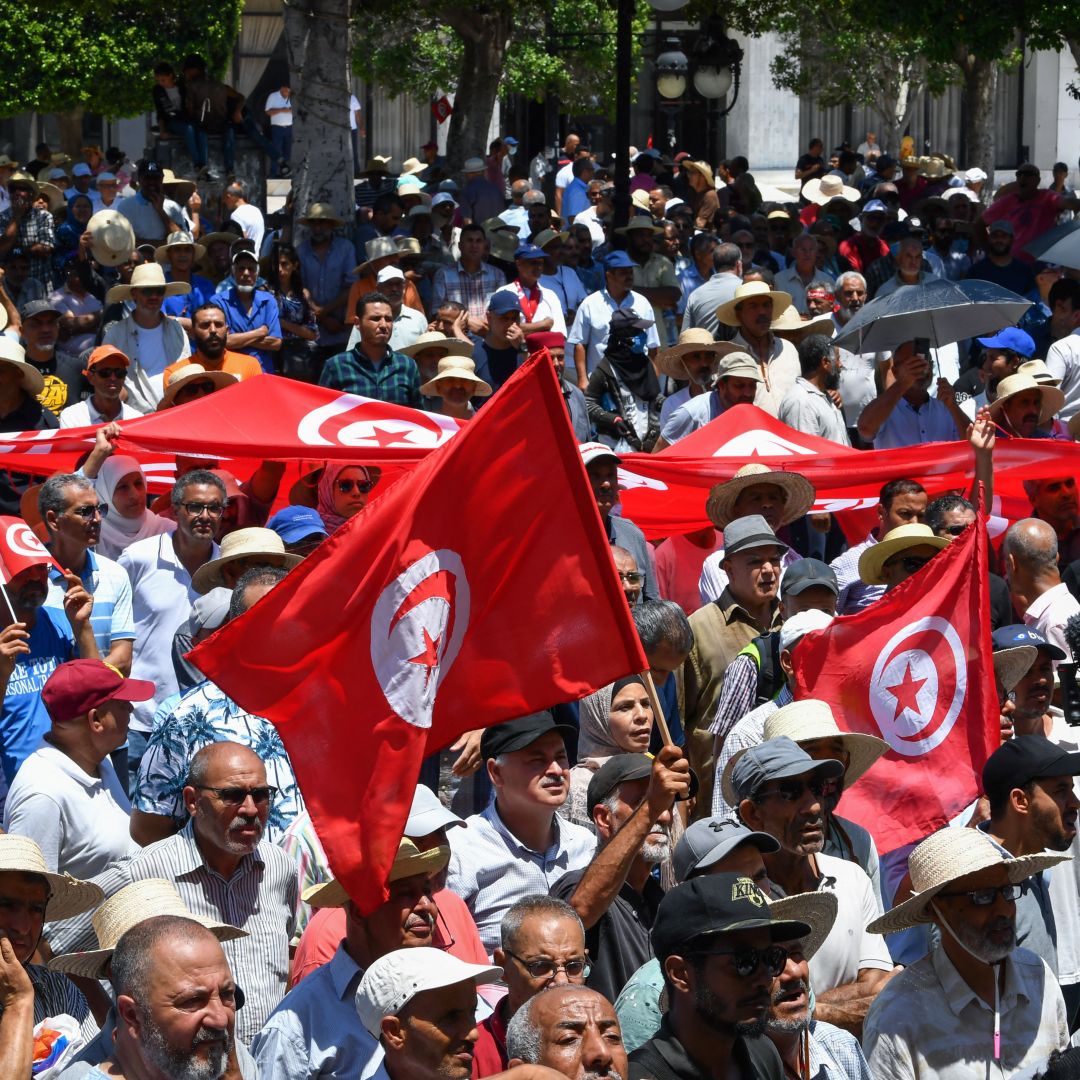 Demonstrators in Tunis, Tunisia, lift national flags during a protest on June 19, 2022, against President Kais Saied and the country’s upcoming constitutional referendum. Demonstrators in Tunis, Tunisia, lift national flags during a protest on June 19, 2022, against President Kais Saied and the country’s upcoming constitutional referendum.