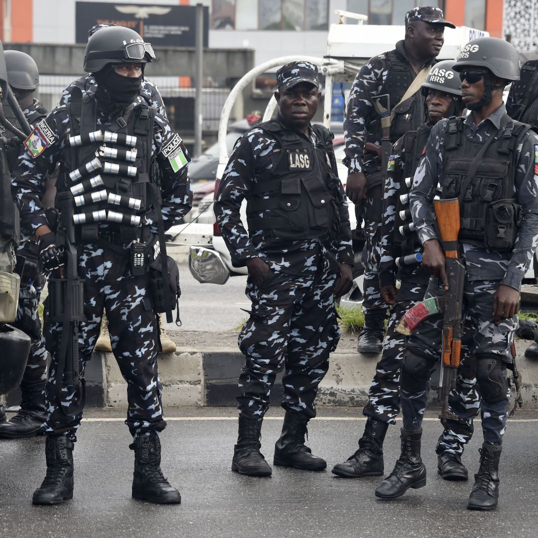 Police officers stand on a street in Lagos on Oct. 1, 2022, as supporters march to campaign for a third-party candidate running in Nigeria's 2023 presidential election. Police officers stand on a street in Lagos on Oct. 1, 2022, as supporters march to campaign for a third-party candidate running in Nigeria's 2023 presidential election.