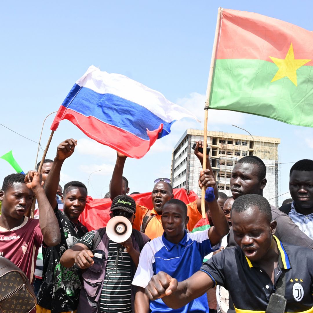 Protesters in Ouagadougou, Burkina Faso, wave Russian and Burkinabe flags on Oct. 4, 2022. 