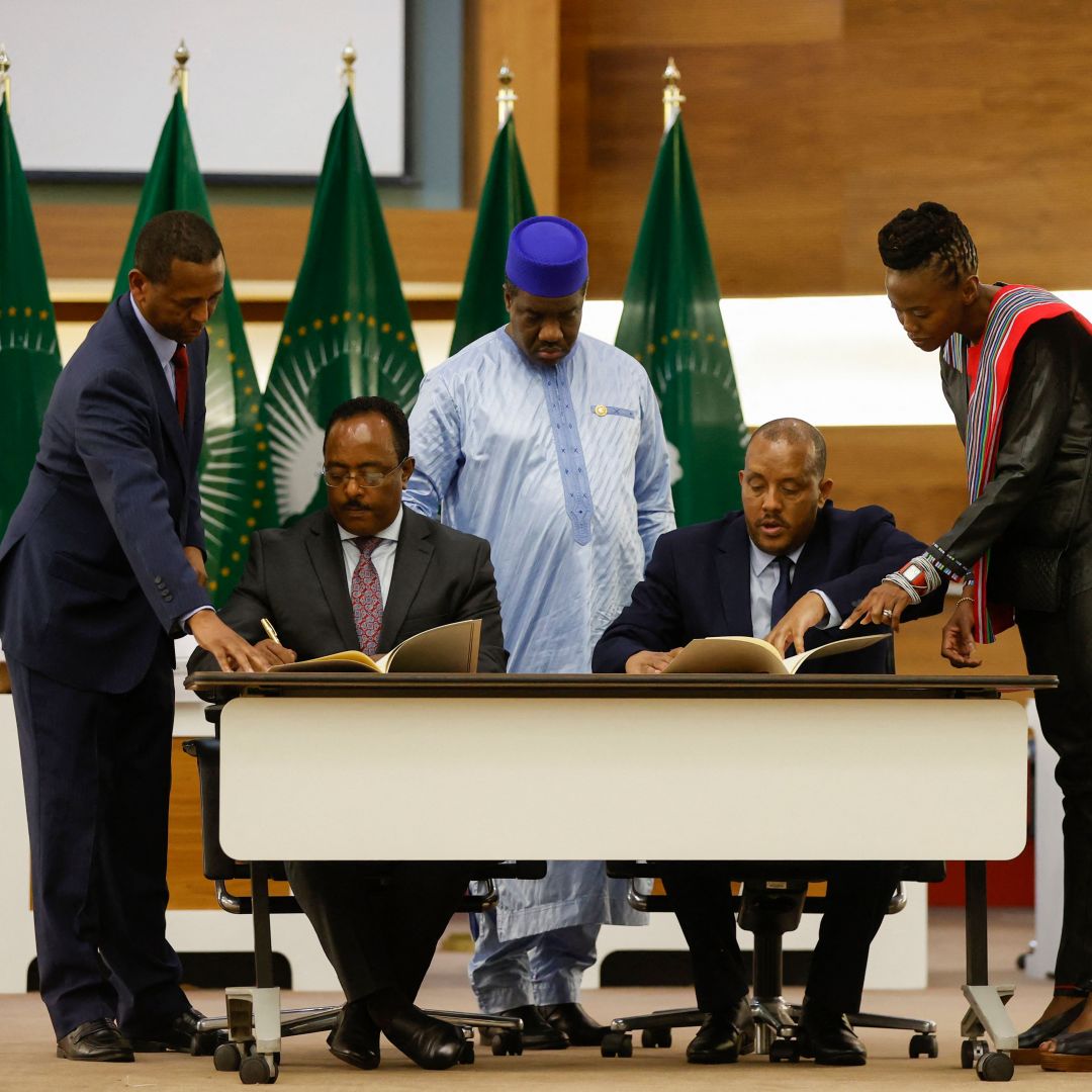 Redwan Hussein (second from the left), a representative of the Ethiopian government, and Getachew Reda (second from the right), a representative of the Tigray People's Liberation Front (TPLF), sign a peace agreement in Pretoria, South Africa, on Nov. 2, 2022.