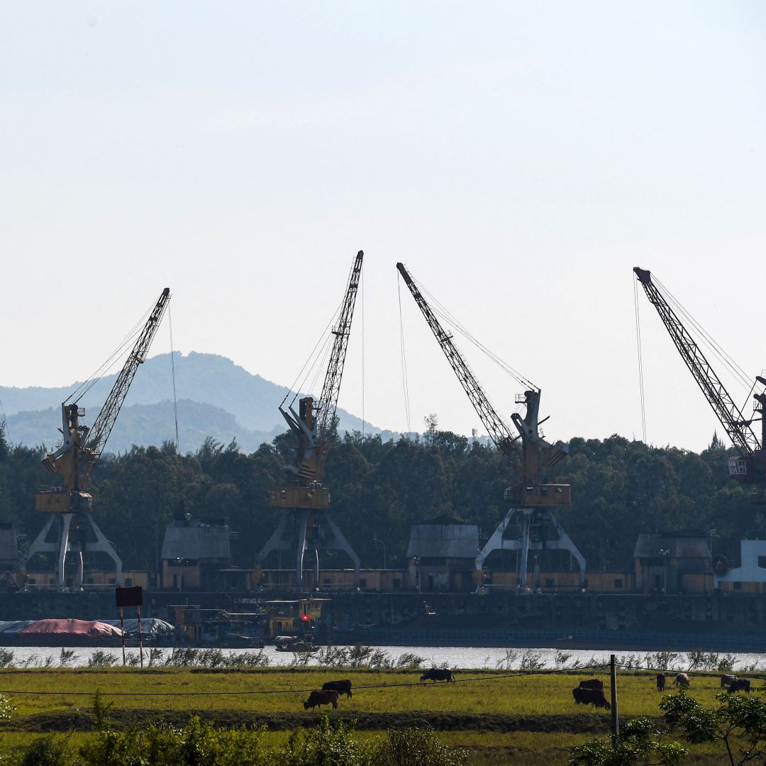 A photo taken on Oct. 14, 2022, shows cranes picking up coal at a port of the Pha Lai thermal power plant in Vietnam's Hai Duong province. A photo taken on Oct. 14, 2022, shows cranes picking up coal at a port of the Pha Lai thermal power plant in Vietnam's Hai Duong province.