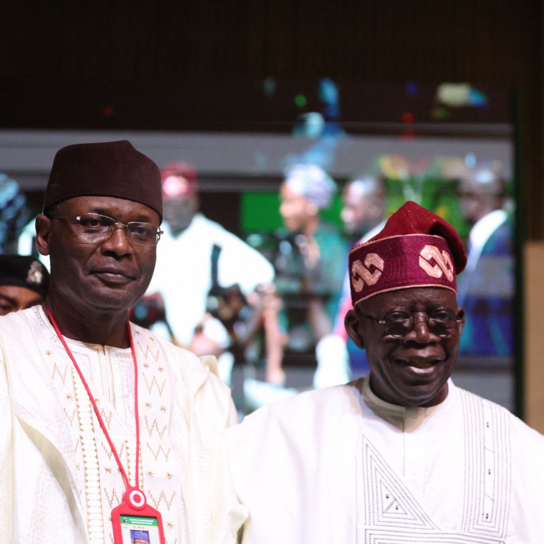 Nigerian President-elect Bola Tinubu (right) and the chairman of the country's Independent National Election Commission (INEC), Yakubu Mahmood, look on during a ceremony in Abuja on March 1, 2023. 