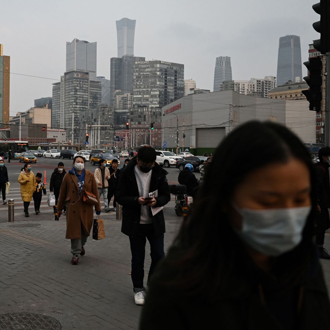 People walk on a street at the end of the workday in Beijing, China, on March 17, 2023. People walk on a street at the end of the workday in Beijing, China, on March 17, 2023.