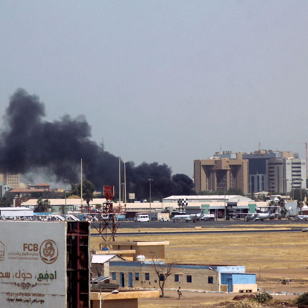 Heavy smoke billows above buildings near the Khartoum airport on April 15, 2023, amid clashes between the army and paramilitary troops. 