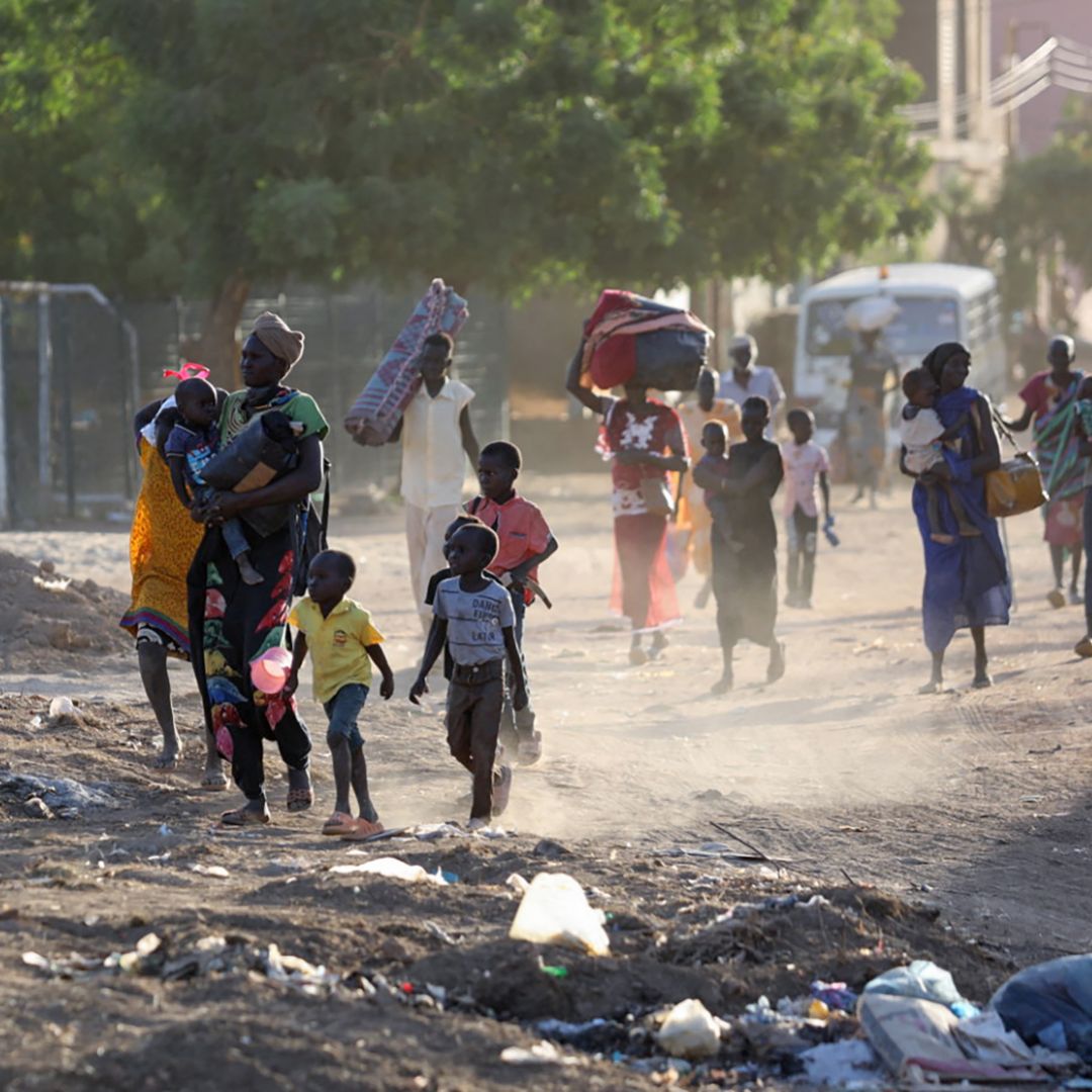 People flee their neighborhoods in Khartoum, Sudan, amid fighting between the army and paramilitary troops on April 19, 2023. 