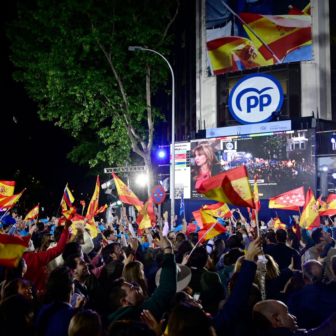 Supporters of Spain's center-right Popular Party (PP) gather outside the PP's headquarters in Madrid on May 28, 2023, to celebrate the party's strong performance in recent regional elections. Supporters of Spain's center-right Popular Party (PP) gather outside the PP's headquarters in Madrid on May 28, 2023, to celebrate the party's strong performance in recent regional elections.