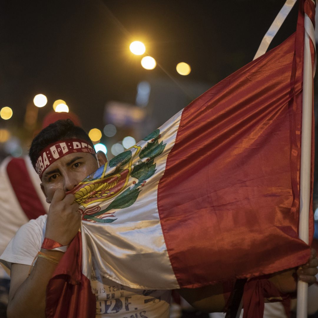 A supporter of ousted Peruvian President Martin Vizcarra embraces the country’s national flag during a protest in Lima, Peru, on Nov. 14, 2020. A supporter of ousted Peruvian President Martin Vizcarra embraces the country’s national flag during a protest in Lima, Peru, on Nov. 14, 2020.