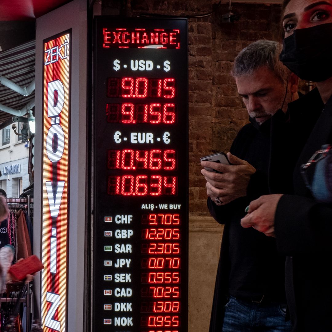 People line up at a currency exchange in Istanbul on Oct.14, 2021, after the firing of central bank officials caused the Turkish lira to drop to a new low against the U.S. dollar. 
