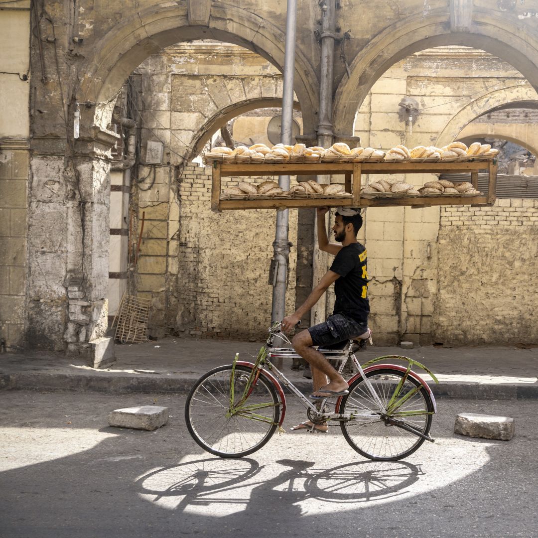 A bakery worker makes a delivery to bread stands in Cairo, Egypt, on May 9, 2022. In April, Egypt introduced price controls on commercially sold bread in response to the rising price of wheat. A bakery worker makes a delivery to bread stands in Cairo, Egypt, on May 9, 2022. In April, Egypt introduced price controls on commercially sold bread in response to the rising price of wheat.