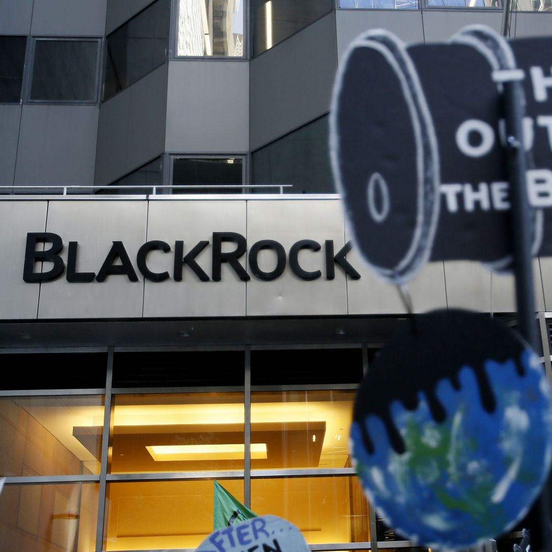 People hold up placards during a climate protest outside investment firm BlackRock's office building in New York City on Oct. 29, 2022. People hold up placards during a climate protest outside investment firm BlackRock's office building in New York City on Oct. 29, 2022.