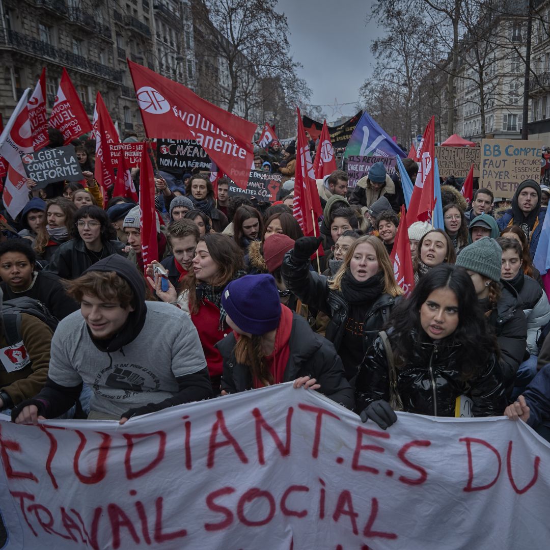 People march in the streets of Paris, France, to protest against President Emmanuel Macron's pension reform plans as part of a nationwide strike on Jan. 19, 2023. 