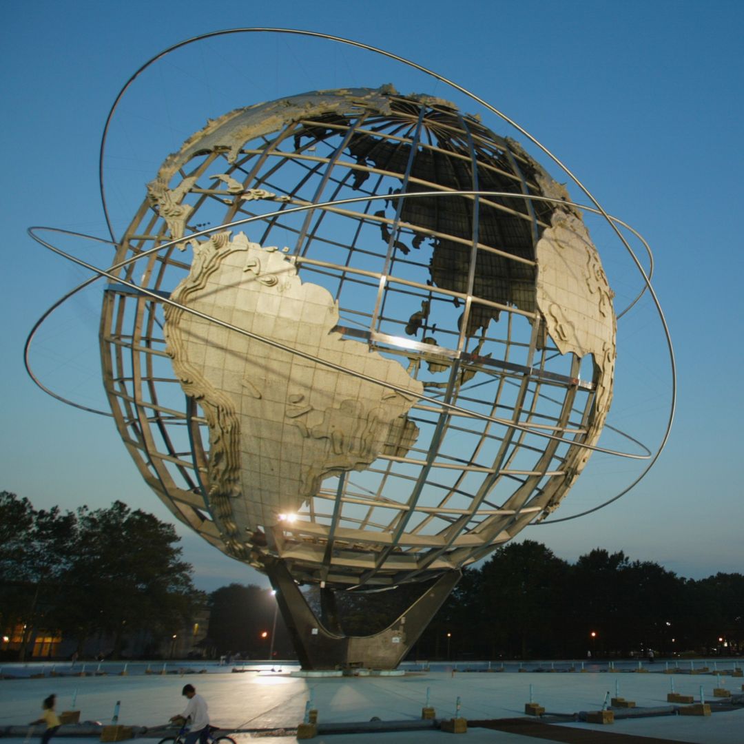 A globe statue is seen at dusk.
