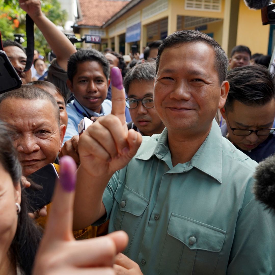 Hun Manet, the eldest son of Cambodia's long-ruling prime minister Hun Sen, shows his finger after voting in the country's general election in Phnom Penh on July 23, 2023. 