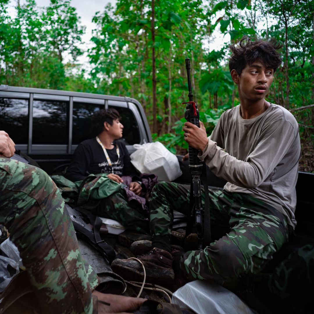 A member of the Karenni Revolutionary Union (KRU) is seen in the back of a pick-up truck on May 10, 2023, in Kayah State, Myanmar.