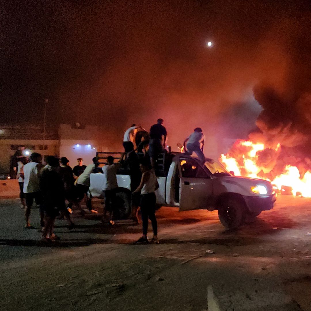 Libyan protesters burn tires in Tripoli on Aug. 28, 2023, in response to reports that their country's foreign minister met with her Israeli counterpart. 