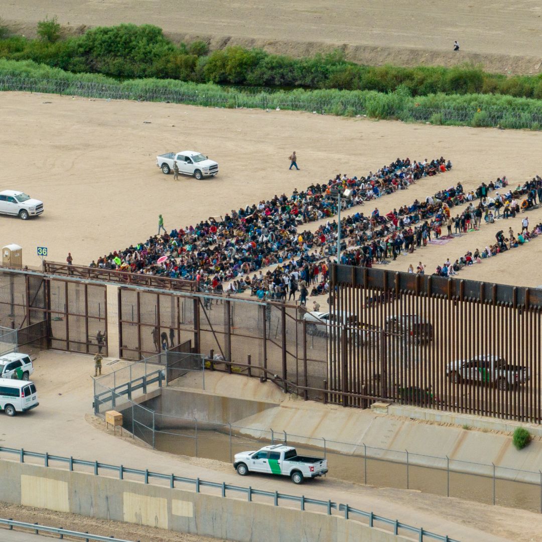 In an aerial view, migrants are seen grouped together while waiting to be processed on the Mexican side of the border in El Paso, Texas, on Sept. 21, 2023. 