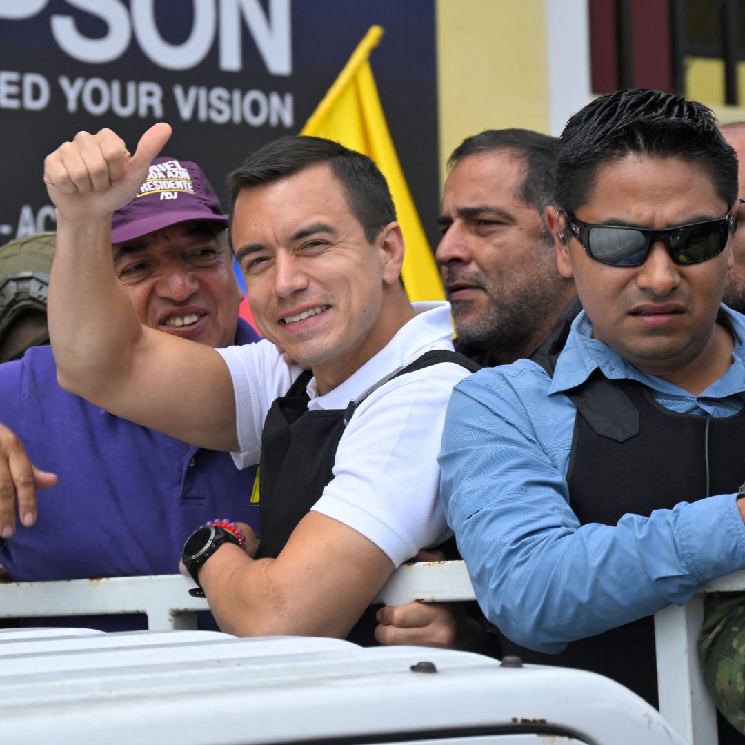 Ecuadorean presidential candidate Daniel Noboa (center) gives a thumbs up as he rides on top of a truck during a campaign caravan in Quito, Ecuador, on Oct. 11, 2023. 