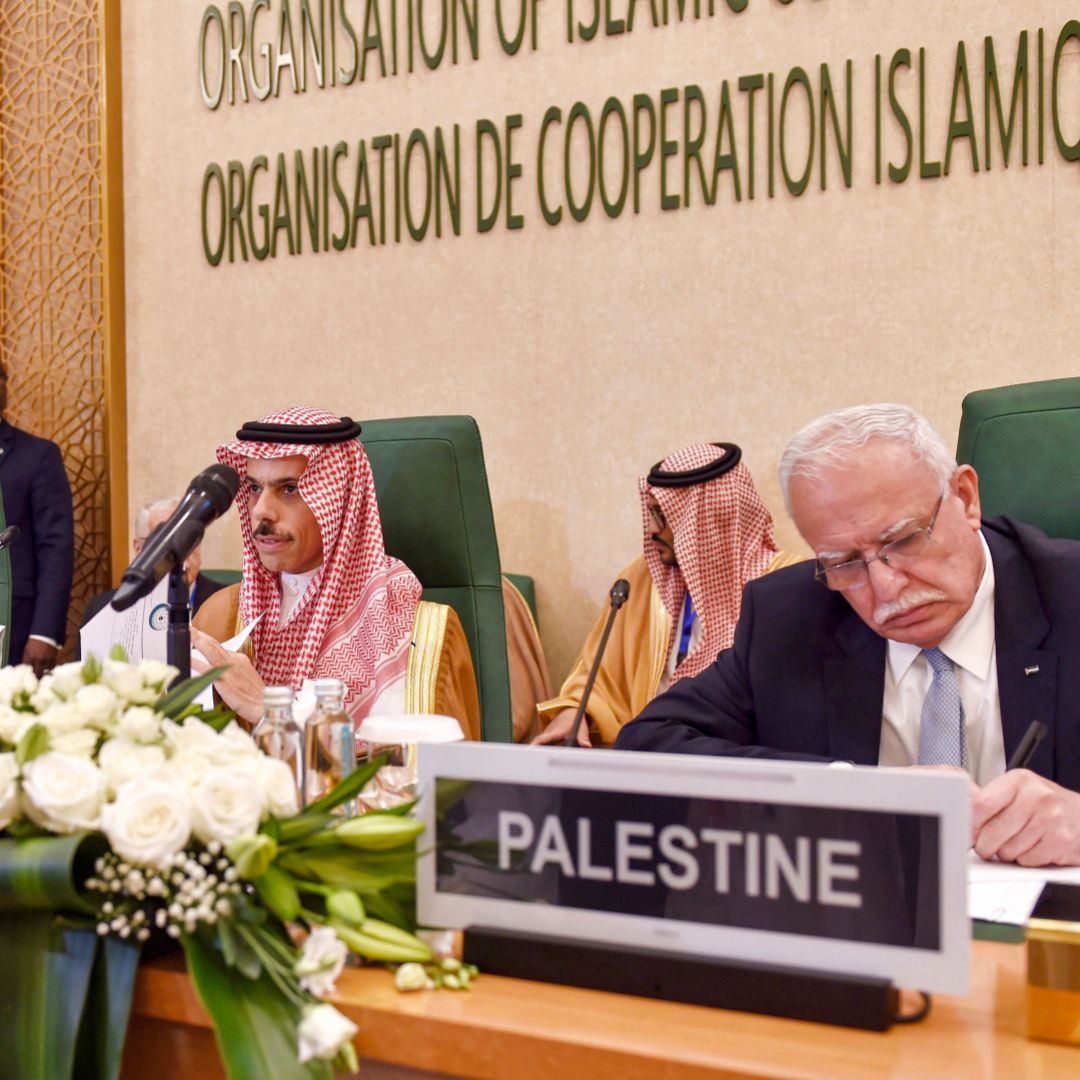 Saudi Foreign Minister Prince Faisal bin Farhan (center) sits next to his Palestinian counterpart during an extraordinary meeting of the Organization of Islamic Cooperation's executive committee regarding the situation in Gaza on Oct. 18, 2023 in Jeddah, Saudi Arabia.