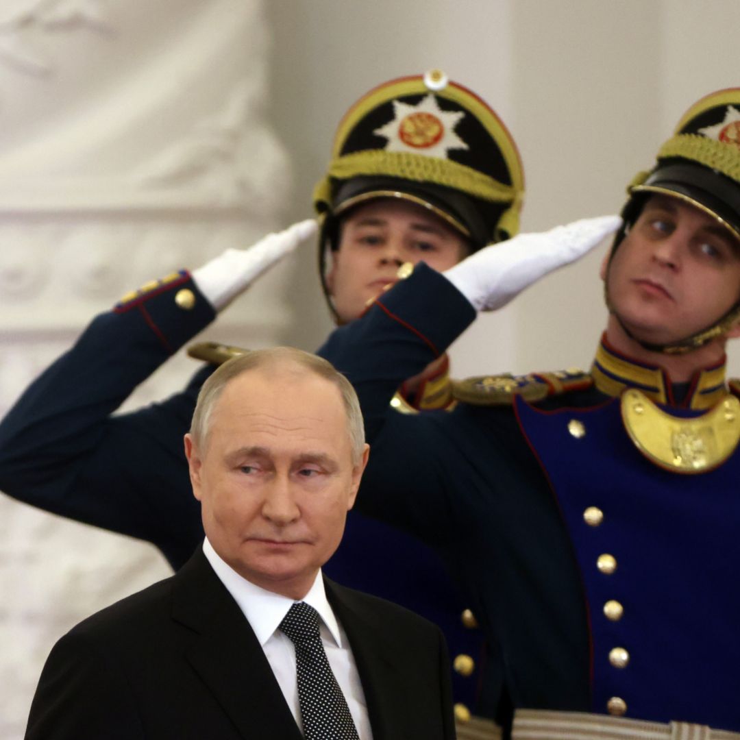 Russian President Vladimir Putin (center) leaves the hall of the Grand Kremlin Palace on Dec. 8, 2023, in Moscow, Russia, as officers of the Presidential Regiment (right) look on.