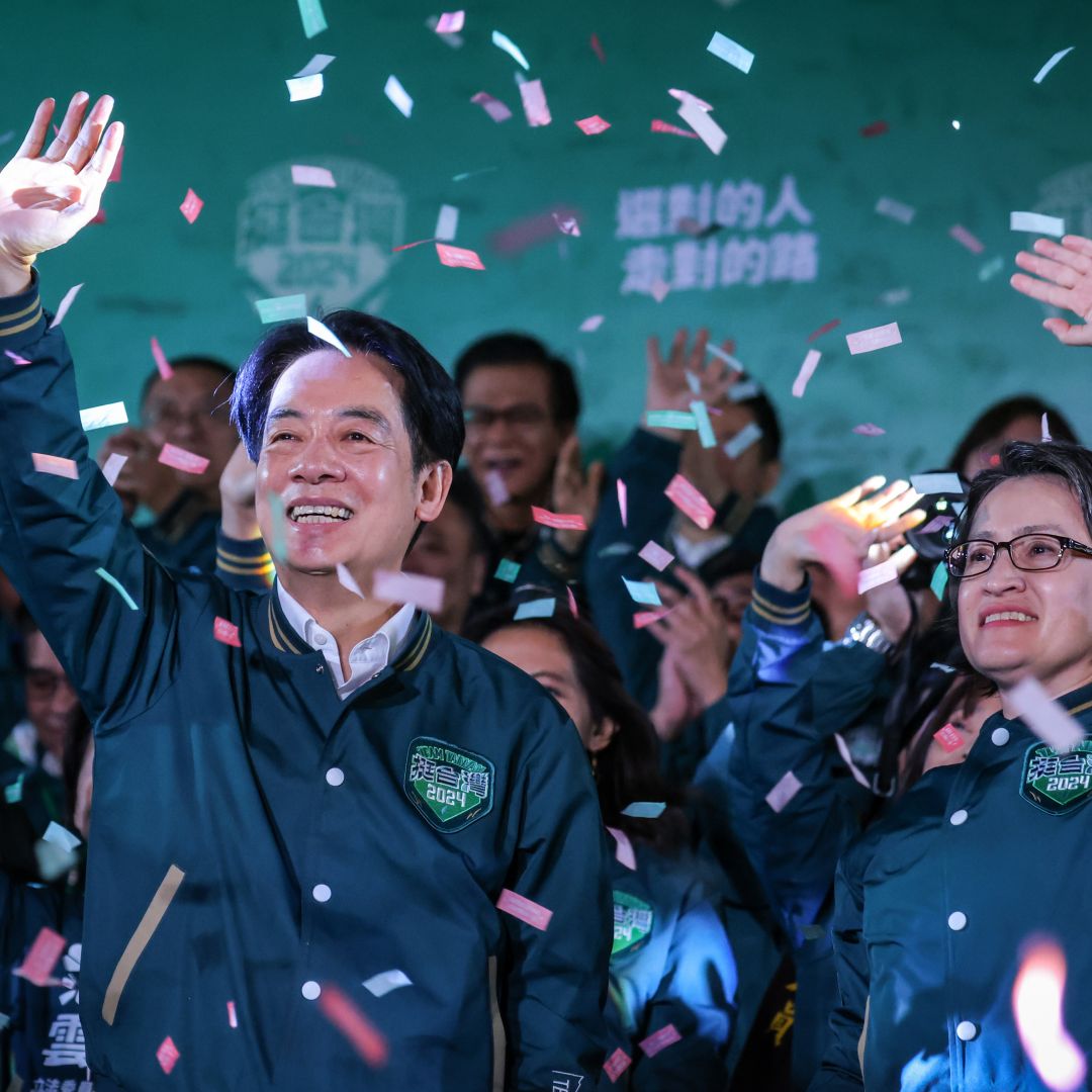 Taiwanese President-Elect, William Lai (left), celebrates alongside his running mate (right) during a rally at the headquarters of the Democratic Progressive Party (DPP) in Taipei, Taiwan, on Jan. 13, 2024, after winning the presidential election.