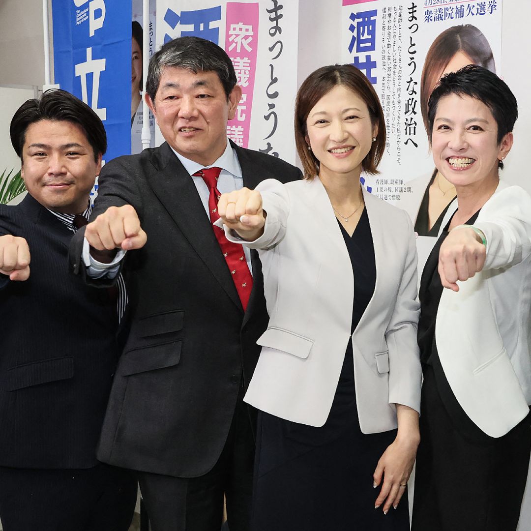 Natsumi Sakai (C) of the main opposition Constitutional Democratic Party of Japan poses with others after receiving news that she won the by-election for the Tokyo No. 15 district seat for the lower house, in Tokyo, Japan, on April 28, 2024.