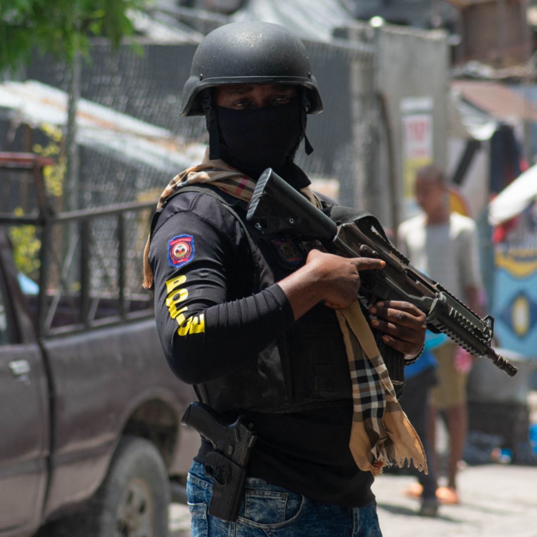 A Haitian police officer controls the area around the country's National Palace in Port-au-Prince on May 1, 2024.