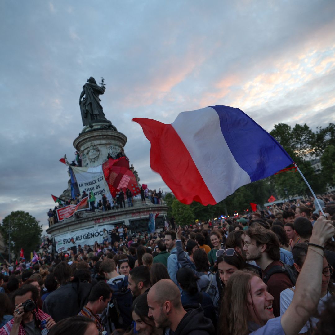 A French flag is waved during a rally following the projected results of the second round of France's legislative election, at Place de la Republique in Paris on July 7, 2024.