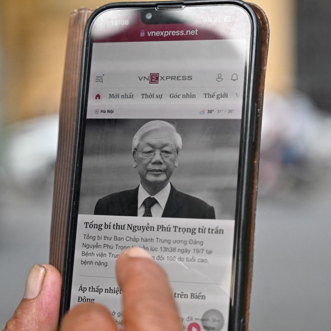 A man in Hanoi, Vietnam, reads a news article on the death of the country’s top leader, Nguyen Phu Trong, on his phone on July 19, 2024.