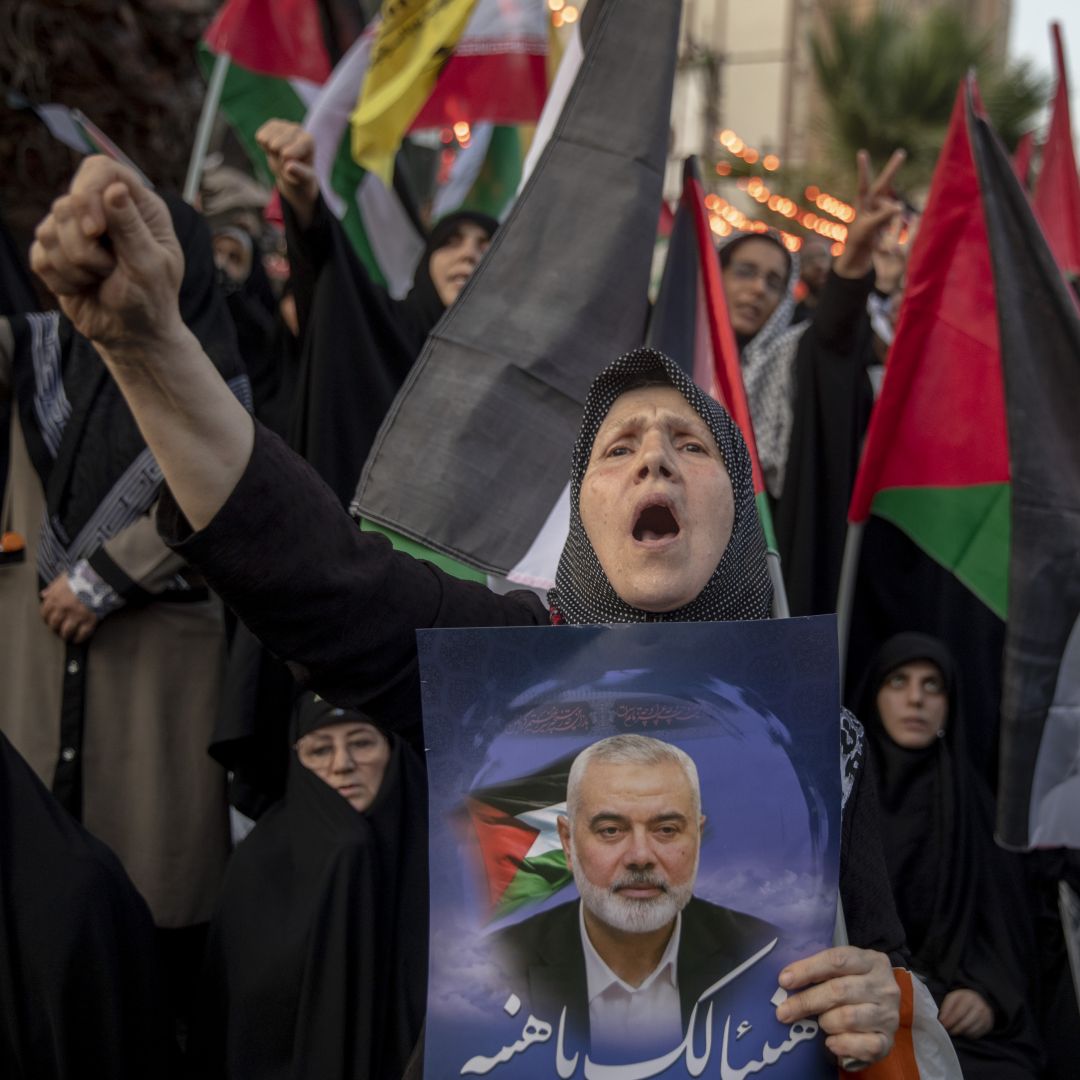 A woman carries a picture of slain Hamas leader Ismail Haniyeh during a protest in Tehran, Iran, on July 31, 2024. 