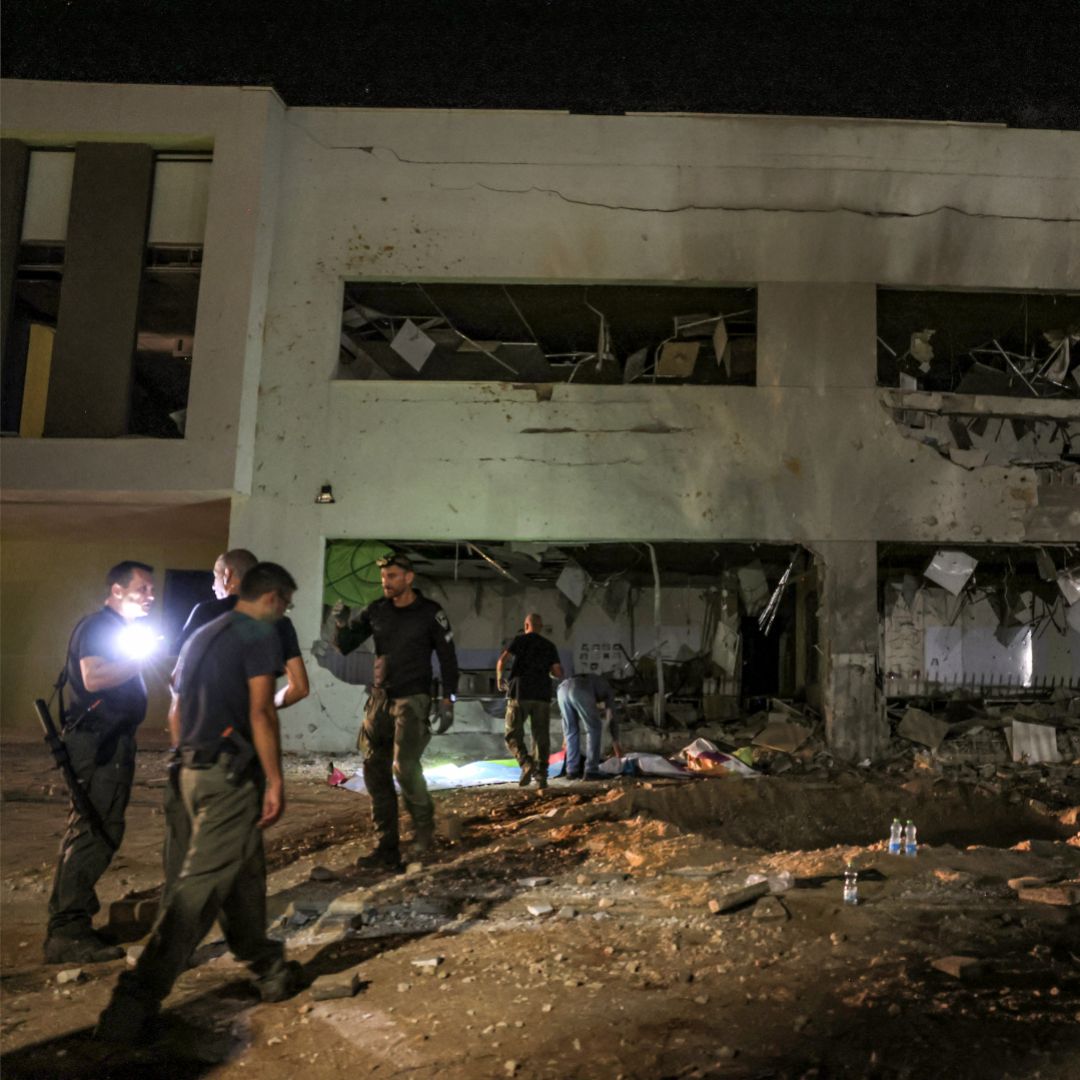 Authorities in Israel's southern city of Gedera assess a damaged school building after a projectile exploded upon impact on Oct. 1, 2024, after Iran launched a barrage of missiles at Israel. 