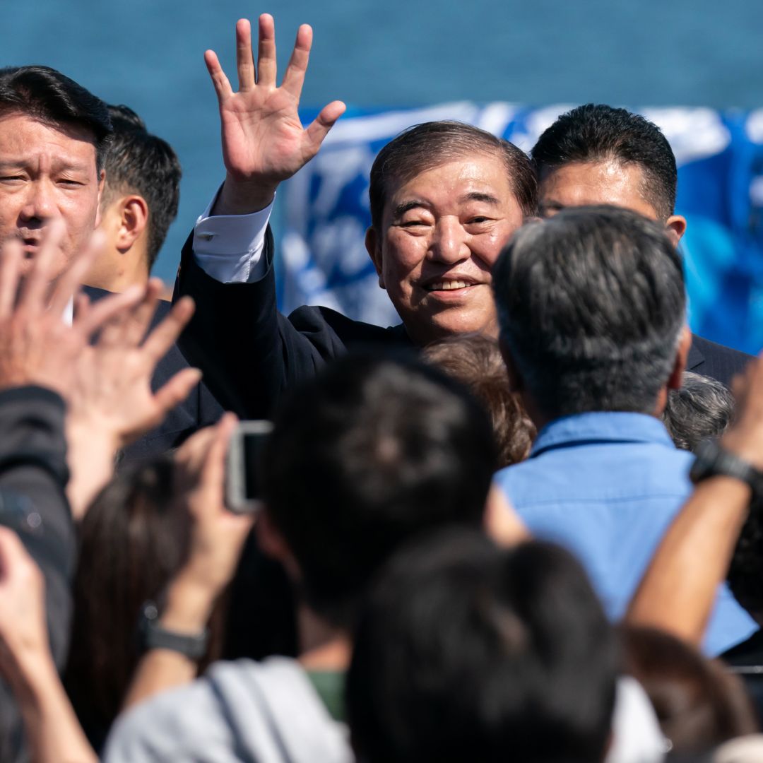 Japanese Prime Minister Shigeru Ishiba (center) waves as he arrives for a campaign rally at Onahama Port in Iwaki, Japan, on Oct. 15, 2024. 