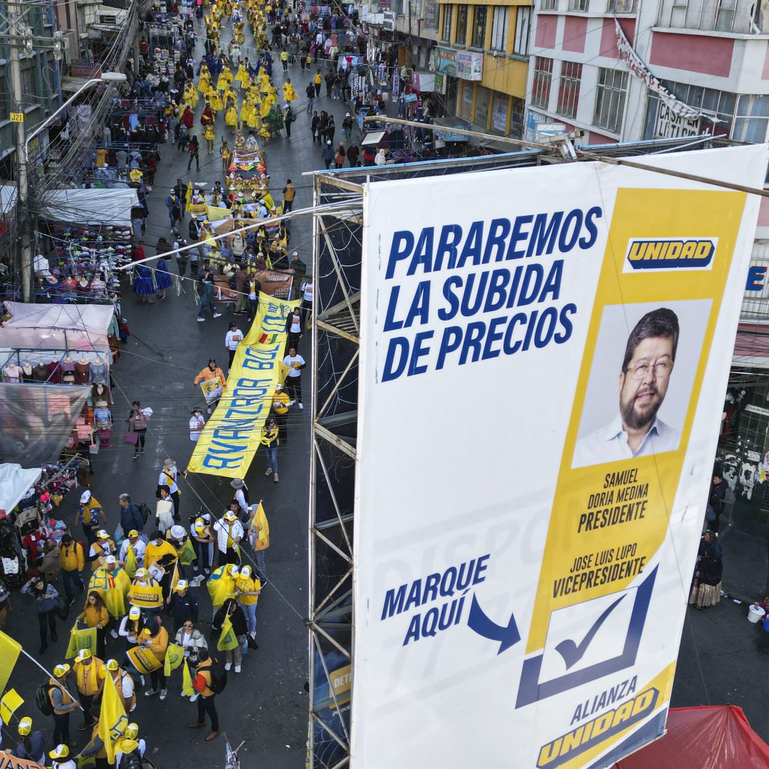 An aerial view shows a campaign poster of Bolivian presidential candidate Samuel Doria Medina and his supporters marching during a rally in La Paz, Bolivia, on Aug. 12, 2025.