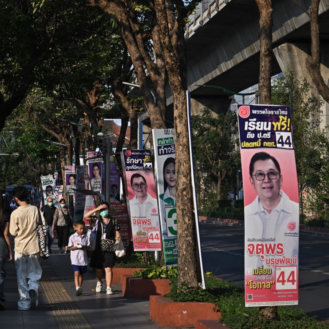 People walk past campaign posters in Bangkok on Feb. 2, 2026, ahead of Thailand's Feb. 8 general election.