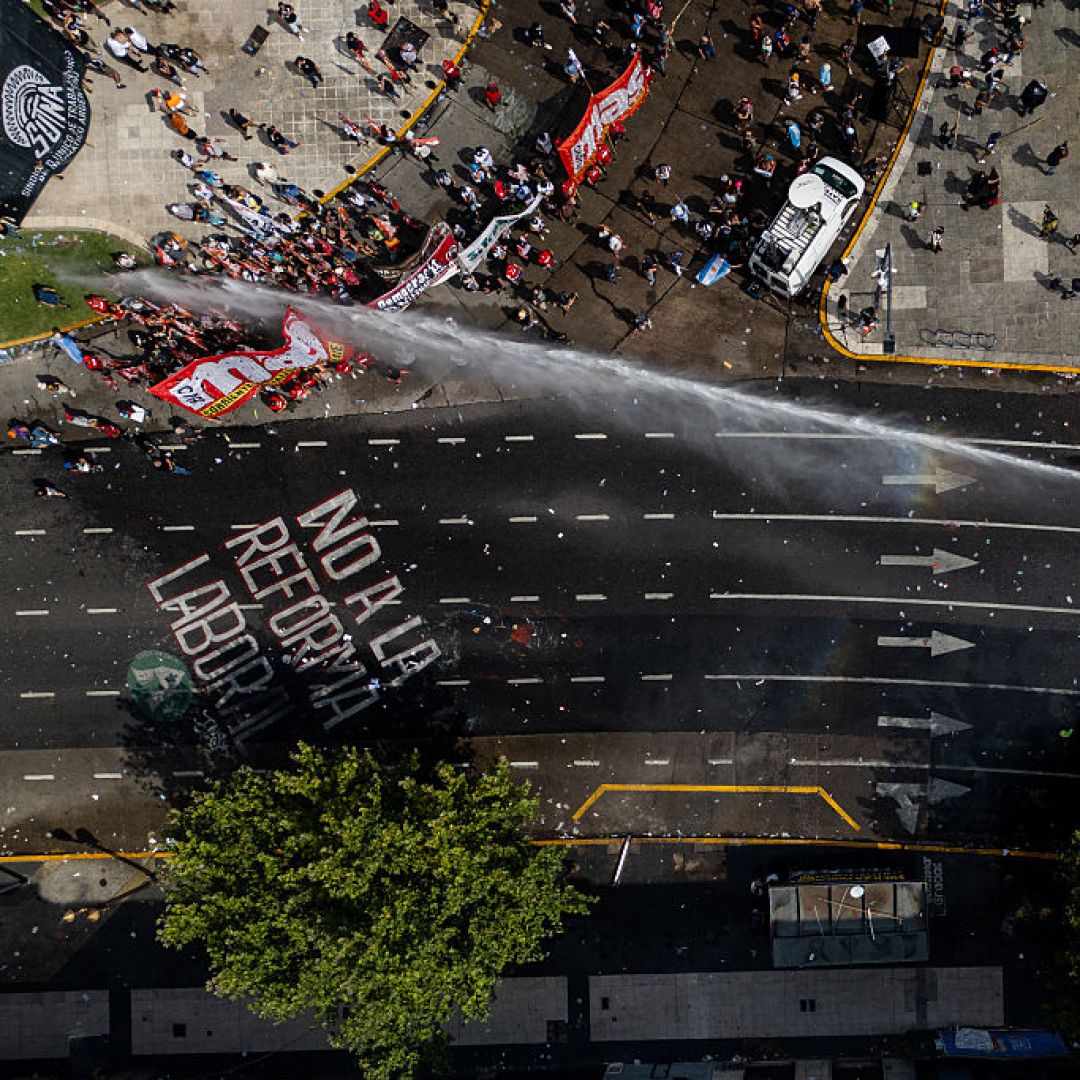 An aerial photo shows Argentinian police using a water cannon truck against protesters opposing labor reforms on Feb. 11, 2026, in Buenos Aires, Argentina.