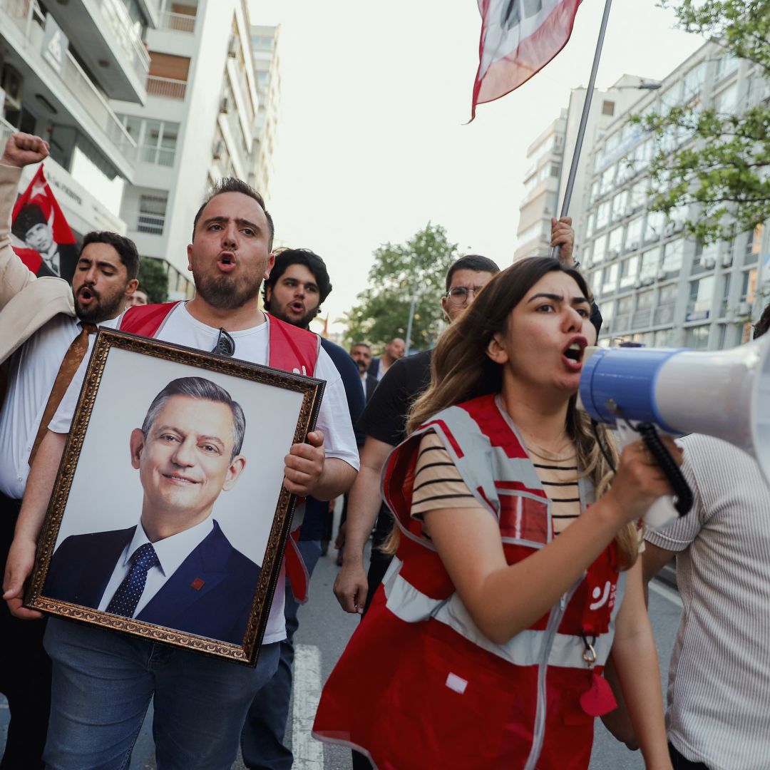 Demonstrators yell through a megaphone and hold a framed portrait of the ousted Republican People's Party (CHP) chairman, Ogur Ozel, during an opposition rally in Izmir, Turkey, on May 24, 2026. Demonstrators yell through a megaphone and hold a framed portrait of the ousted Republican People's Party (CHP) chairman, Ogur Ozel, during an opposition rally in Izmir, Turkey, on May 24, 2026.